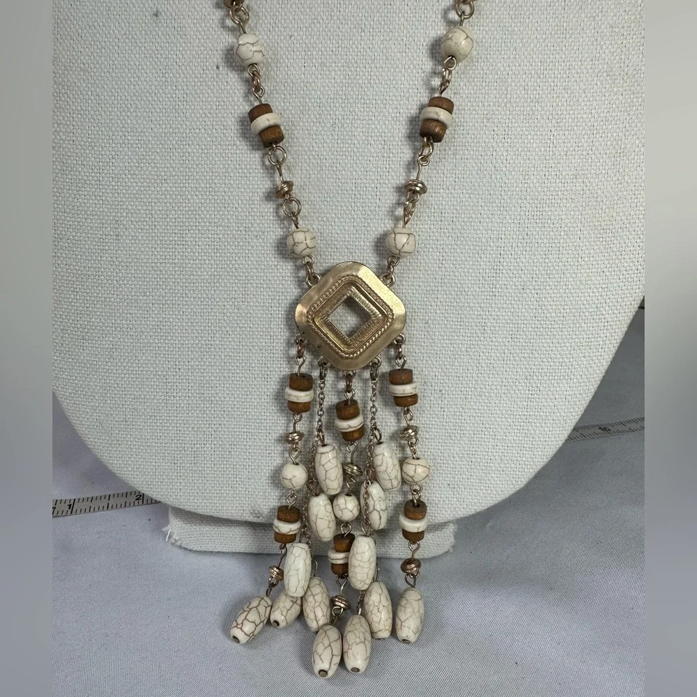 Three neutral tone layering style statement necklaces